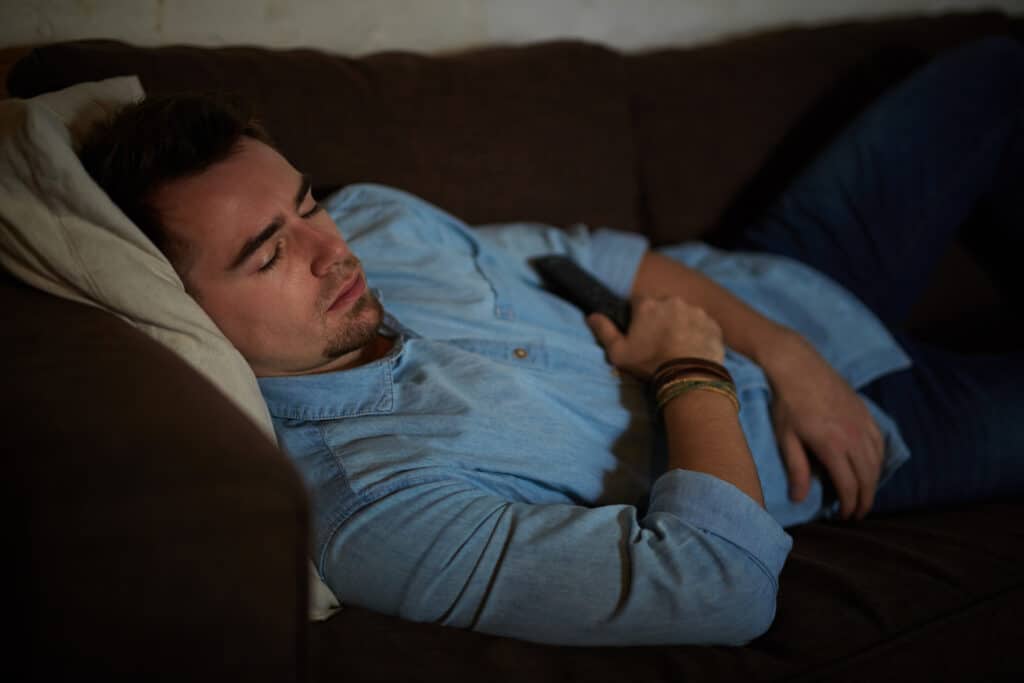 Man sleeping with tv turned on 379628 2