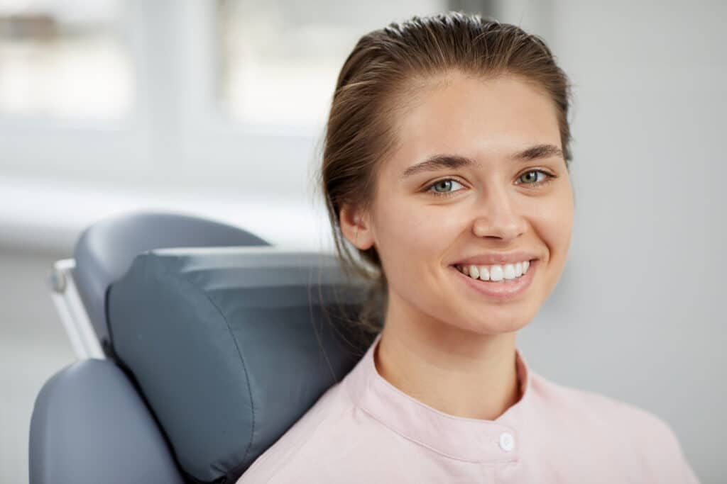 Smiling young woman in dental chair 545483